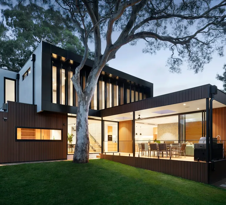 Contemporary home exterior with large windows and outdoor lighting